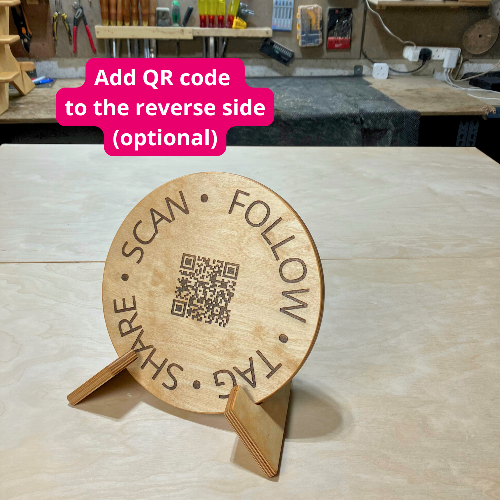 Wooden sign with QR code on a stand in a workshop setting