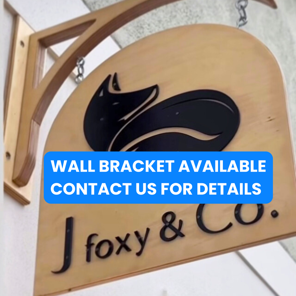Wooden logo sign with black fox logo and text 'J Foxy & Co.' on a natural background attached to awall of a cafe in Summerhill, Co Meath
