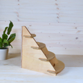 Light plywood tiered corner stand with three curved shelves.