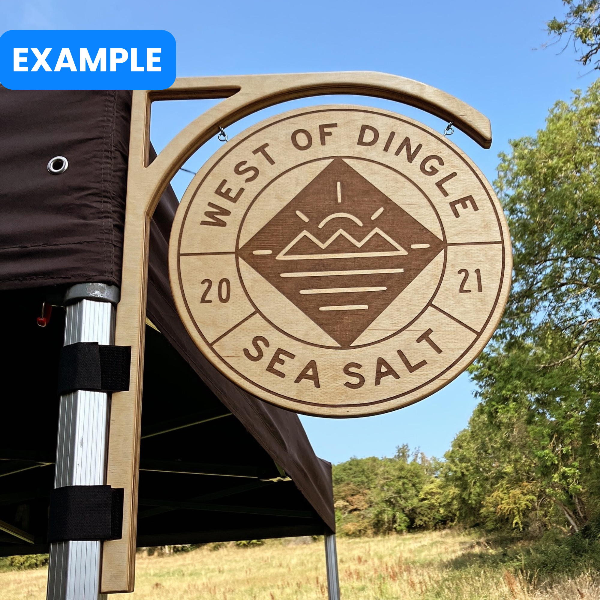 Wooden market sign for 'West of Dingle Sea Salt' with scenic background somwhere in county Kerry, Ireland
