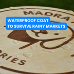 Wooden sign with 'MADRA agus misa' branding and water droplets, text overlay about waterproof coat.