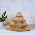 Light brown plywood corner stand with four curved shelves.