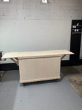 Natural wood portable cart with folding leaf extensions and visible joinery on casters.