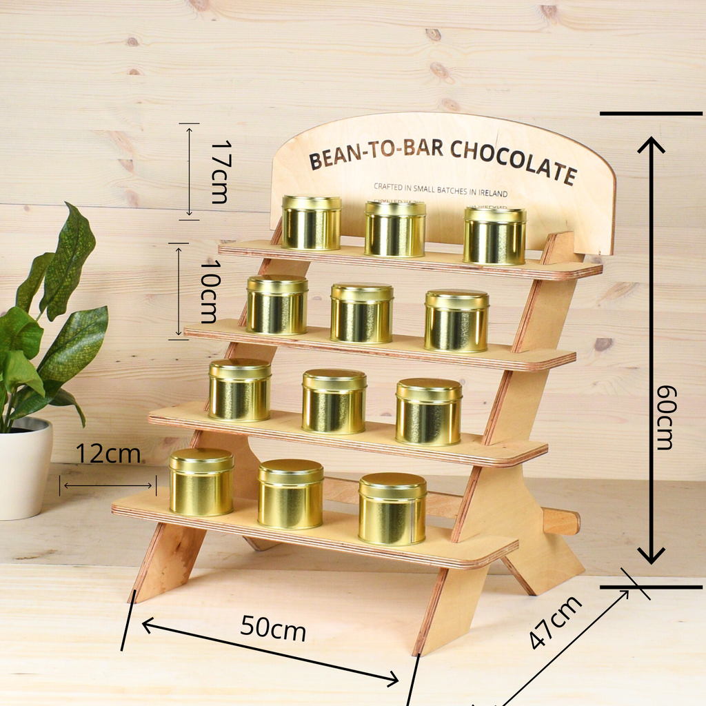Wooden display stand with gold containers labeled 'Bean-to-Bar Chocolate' on a wooden background.