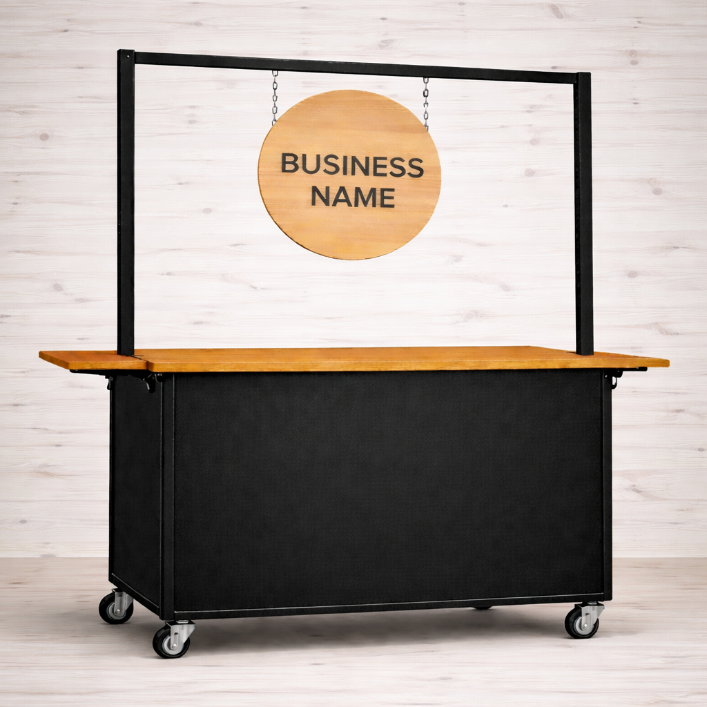 Portable coffee cart with wooden top and black sides, featuring a hanging wooden sign with 'BUSINESS NAME' text handmade in Dublin.