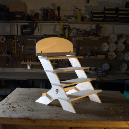 Wooden chair with white base on a wooden table in a workshop setting